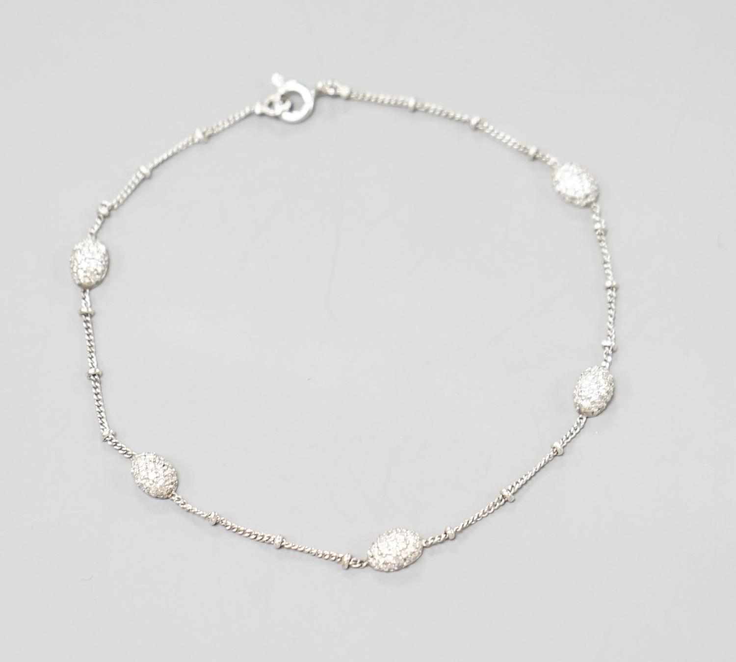 A modern 750 white metal and diamond chip set demi lune link bracelet, 19cm,gross weight 3.1 grams. - Image 2 of 4