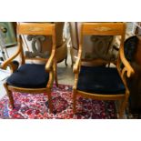 A pair of Empire style cherry elbow chairs with gilt metal dolphin mounts, width 65cm, depth 56cm,