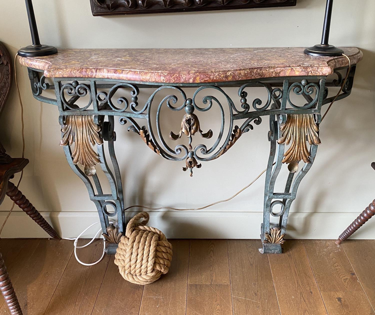 A French painted and gilt wrought iron console table, with serpentine marble top, width 132cm
