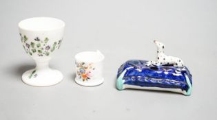 A mid 19th century Staffordshire porcelain Dalmatian pen holder and a cornflower spray egg cup and a