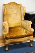 A Chippendale style gold velvet wing backed chair