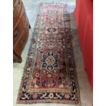 A Karajeh red ground runner, 300 x 100cm