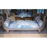 A late 19th century French cast metal day bed, with blue fabric upholstery and two bolsters, width