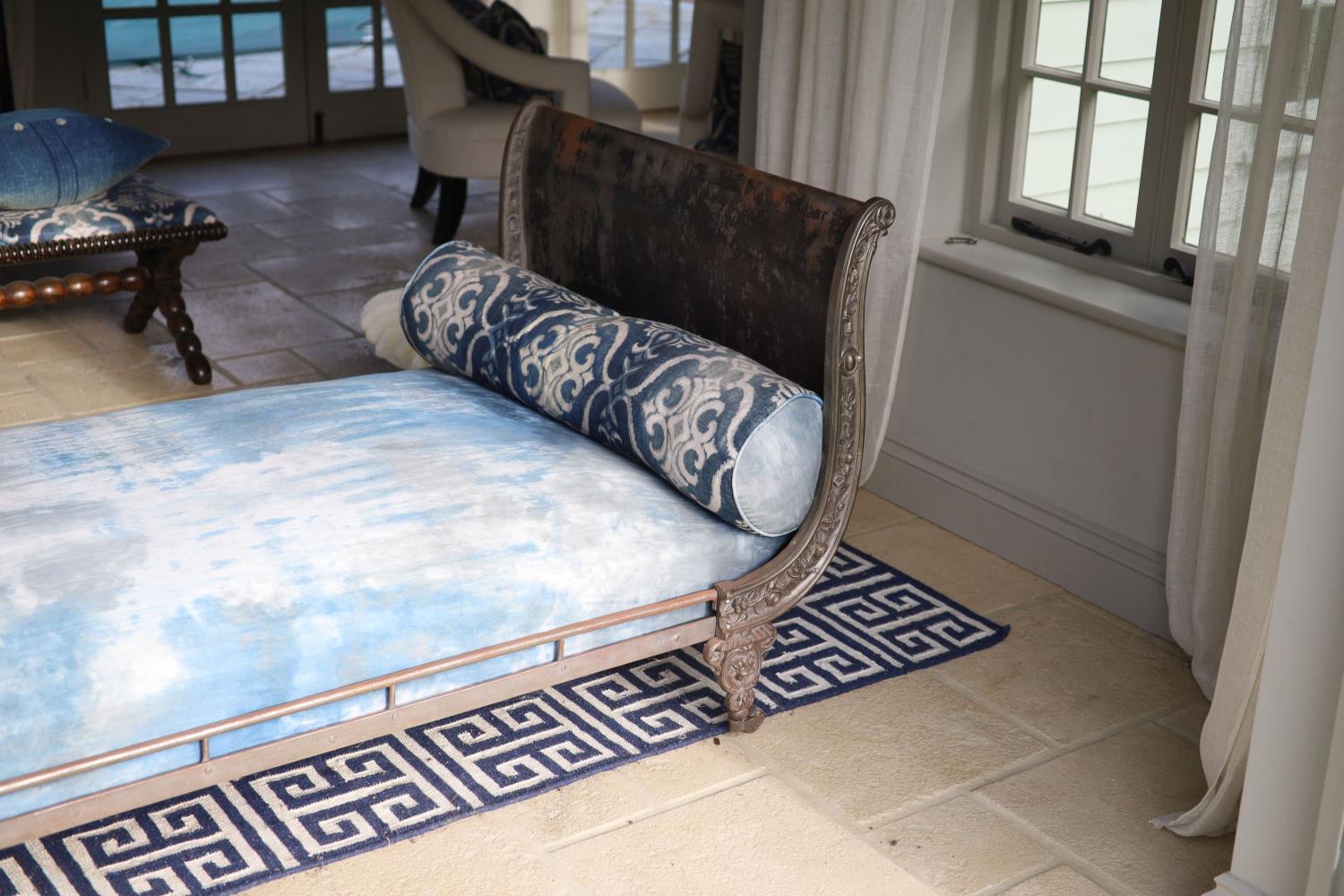 A late 19th century French cast metal day bed, with blue fabric upholstery and two bolsters, width - Image 2 of 4