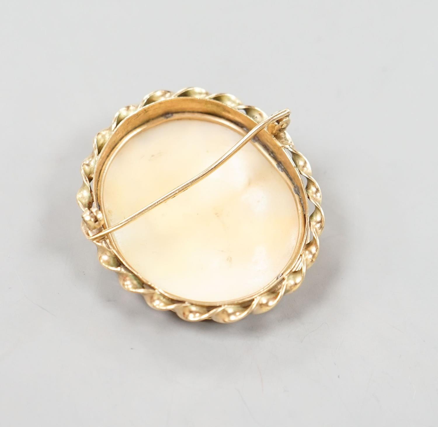 A late Victorian yellow metal mounted oval cameo shell brooch, carved with the bust of a lady to - Image 3 of 3