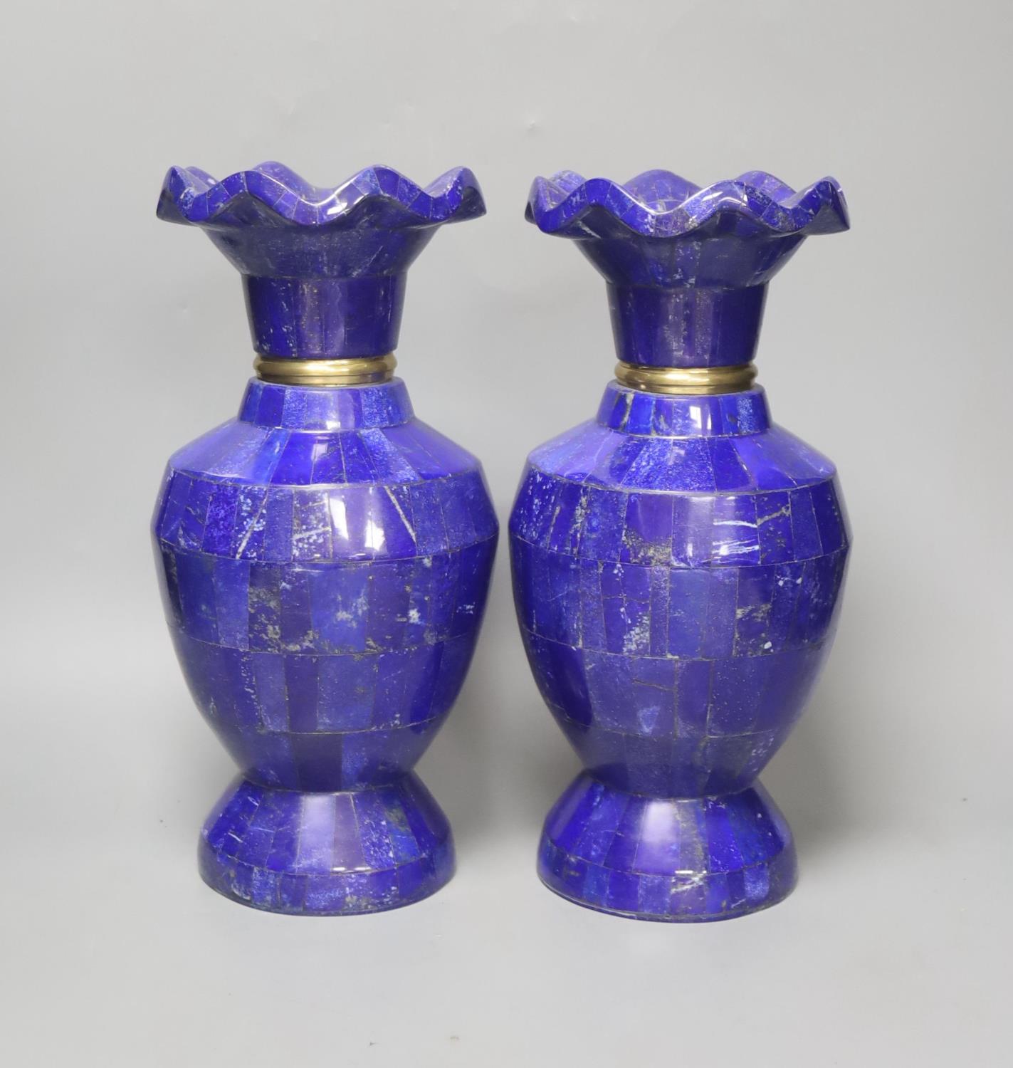 A pair of Lapis Lazuli overlaid vases, with scalloped rim and gilt metal collars, 30cm high