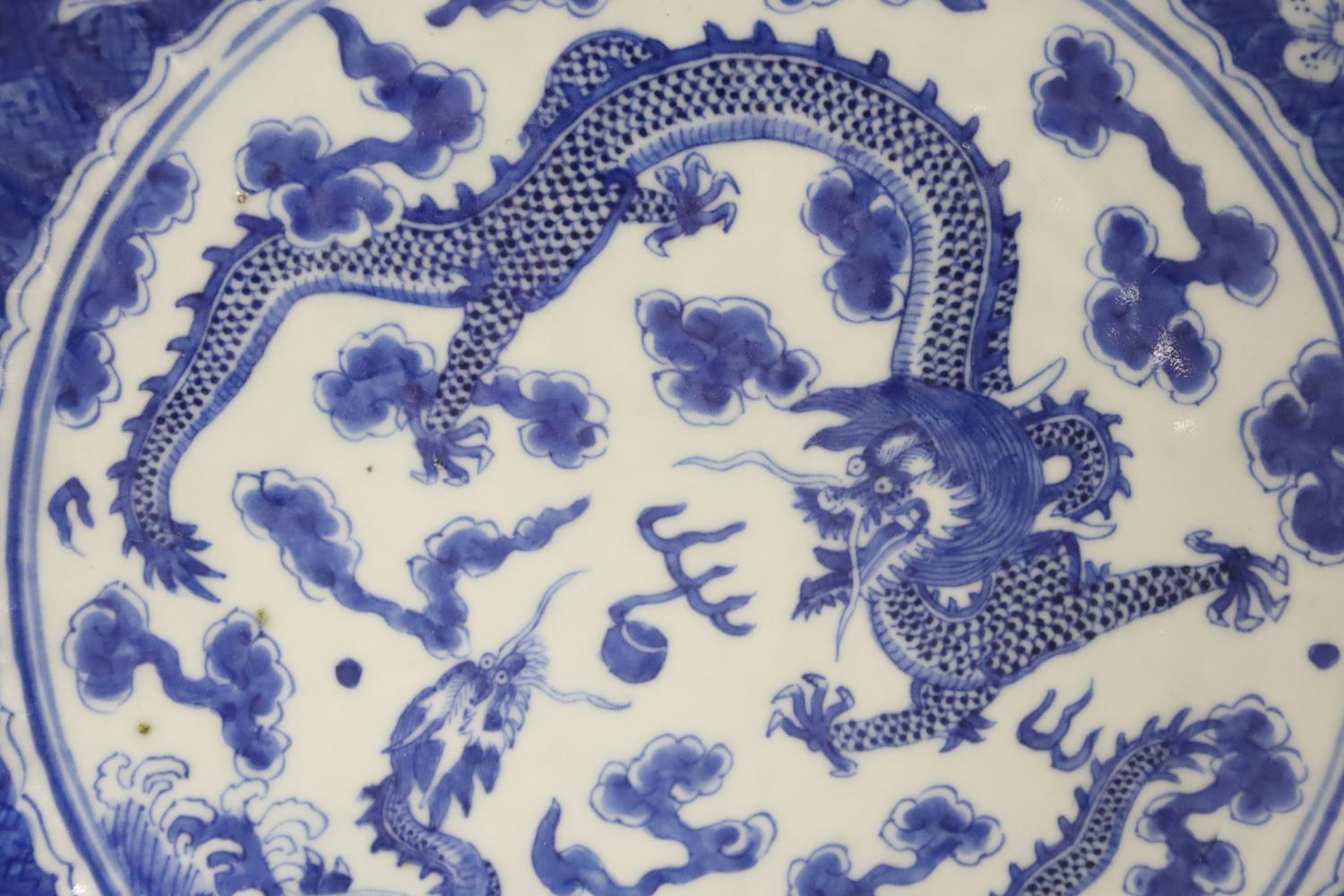 A Chinese blue and white dragon dish, 19th century with a Chenghua mark, 29cm - Image 2 of 3