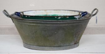 Three oval enamel and galvanised containers, largest width 88cm