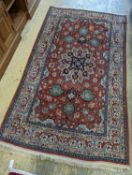 A Tabriz brick red ground rug, 230 x 138cm