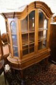 An 18th century style Dutch walnut display case, with double-arched moulded cornice over a pair of