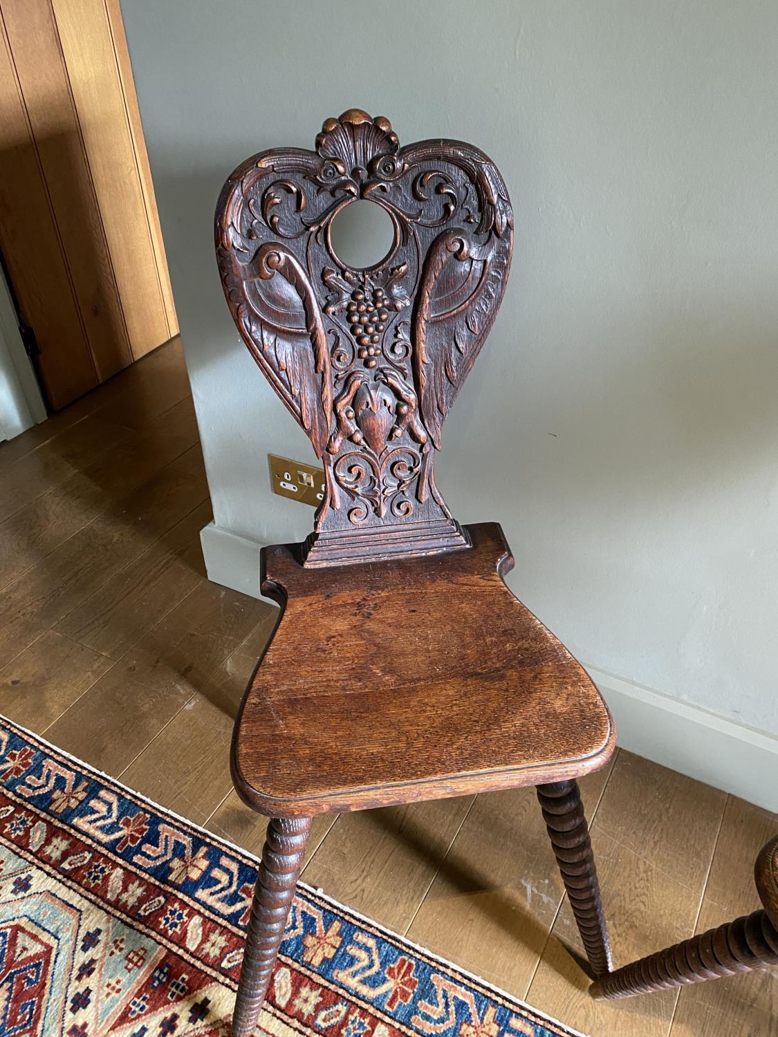 A pair of 19th century Swiss carved oak hall chairs, with vine and scroll backs and tapered bobbin - Image 2 of 2