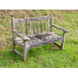 A pair of weathered teak garden benches, width 158cm