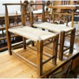 A pair of French provincial oak and beech stools with elongated rush seats, width 31cm, length 67cm,