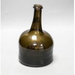 An English dark green glass ‘mallet’ wine bottle, c.1740, 21cm high