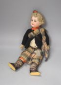 An AM bisque doll, Scottish dress. 30cm