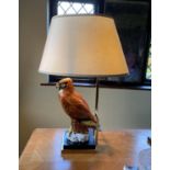 A Continental porcelain owl lamp base, with lacquered brass mounts, height of base 45cm