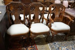 A set of twelve George II style carved walnut dining chairs, two with arms