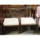 A pair of mid 20th century Chinese Hongmu elbow chairs with cushion seats, width 58cm, depth 49cm,