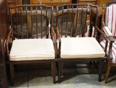 A pair of mid 20th century Chinese Hongmu elbow chairs with cushion seats, width 58cm, depth 49cm,