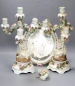 A pair of 19th century German porcelain three branch candelabra (a.f.) and an oval porcelain