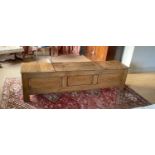 A 17th century style elm blanket box, with central rising lid and panelled front, width 180cm