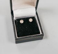 A pair of 750 white metal and solitaire diamond ear studs, gross weight 2 grams,stone diameter