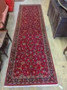 A Kashan red ground runner, 340 x 101cm