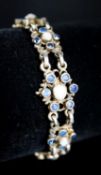 A continental gilt white metal, sapphire and split pearl flower head cluster set bracelet