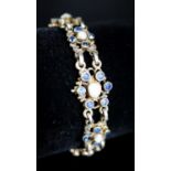 A continental gilt white metal, sapphire and split pearl flower head cluster set bracelet