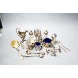 A group of small silver including condiments, match strike, cream jug, plated knife rests etc.