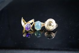 Two 9ct and gem set dress rings, gross 6.8 grams and a 333(8ct) and gem set dress ring, gross 5.6