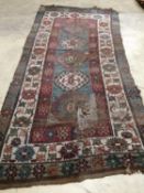 An antique Kazak rug, 310 x 150cm