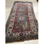 An antique Kazak rug, 310 x 150cm