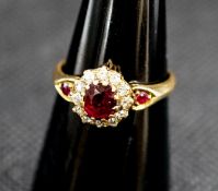 A late Victorian 18ct gold ruby and diamond cluster ring, with ruby set shoulders, size M, gross