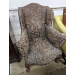 A Queen Anne revival upholstered walnut wing armchair, width 78cm, depth 78cm, height 96cm