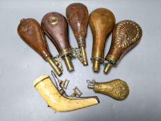 Six powder/shot flasks, 4 copper and brass, 2 leather and brass, together with a carved powder