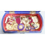 A group of Masonic medals some silver gilt, in a painted wood box