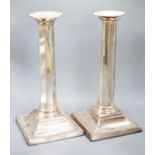 A pair of Edwardian silver candlesticks, with panelled columns, Birmingham, 1905, 20.8cm, weighted.