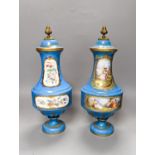 A pair of Sevres style porcelain bleu celeste ground vases and covers, 34cm