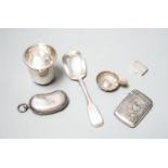 A George V silver twin sovereign kidney shaped case, 65mm, a silver spoon, silver tot , silver