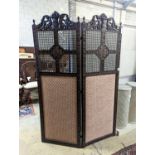 A 1920's carolean style oak and cane work two fold dressing screen, each panel width 60cm, height