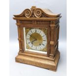 A late 19th century German oak cased eight day mantel clock