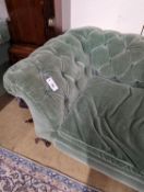 A late Victorian double drop arm Chesterfield settee upholstered in green fabric, length 186cm,