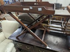 A 19th century rectangular mahogany butler's tray on folding stand, width 24cm, depth 49cm, height