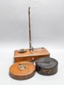 A Victorian cased weighing scale, two papier mache wine coasters and surveyor's measure.