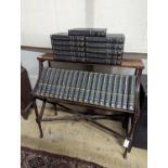 A Liberty style mahogany book stand, together with a set of the Encyclopedia Britannica, width 91cm,