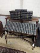 A Liberty style mahogany book stand, together with a set of the Encyclopedia Britannica, width 91cm,
