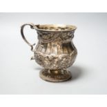 A George IV embossed silver christening mug, London, 1825, height 95mm, 206 grams.