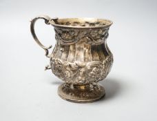 A George IV embossed silver christening mug, London, 1825, height 95mm, 206 grams.
