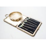 A 1930's silver taste vin and a cased set of six sterling and enamel cocktail sticks.